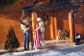 Family decorate his wooden house for Christmas