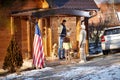 Family decorate their wooden house for Christmas