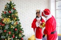 Family decorating a Christmas tree and Father giving Christmas G Royalty Free Stock Photo