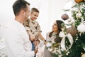 Family of 3 decorating a Christmas tree at home Royalty Free Stock Photo