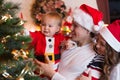 Family decorating Christmas tree in living room Royalty Free Stock Photo