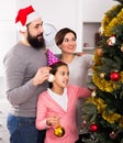 Family decorating Christmas tree Royalty Free Stock Photo