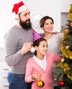 Family decorating Christmas tree Royalty Free Stock Photo