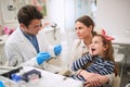 Family in dentistÃ¢â¬â¢s office.girl suffering from tooth pain