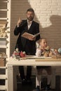 Family by desk with school supplies. Girl and father