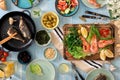 Family dinner table with shrimp, fish grilled, salad, snacks, le