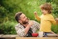 family dinner time. father and son eating outdoor. happy fathers day. Little boy with dad eat cereal. summer picnic Royalty Free Stock Photo