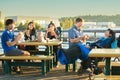 Family with disabled son in wheelchair eating burgers outdoors Royalty Free Stock Photo