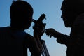 Family discovering the moon with a telescope