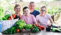 Family discusses the harvest of vegetables at the table of the village house