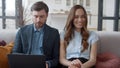 Family discussing business in home office. Couple working on laptop together. Royalty Free Stock Photo