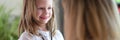 Family doctor lets her young patient play with stethoscope. Royalty Free Stock Photo