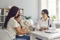 Family doctor. Medical doctor woman consults mother and child sitting at the table in the office of the clinic.