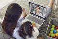 Family doctor online. Mother and baby greet the doctor have a video call laptop to the doctor at home.