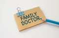 FAMILY DOCTOR text written in card with blue pencil. Medical concept.