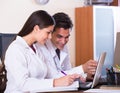 Family doctors with stethoscope working in office together Royalty Free Stock Photo