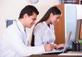 Family doctors with stethoscope working in office together Royalty Free Stock Photo