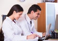 Family doctors with stethoscope working in office together Royalty Free Stock Photo