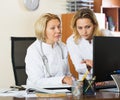 Family doctors therapeutists discussing difficult case in office Royalty Free Stock Photo