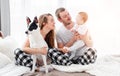 Family with dog in the bed Royalty Free Stock Photo