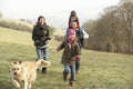 Family and dog on country walk in winter Royalty Free Stock Photo