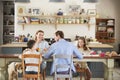 Family with dog eating together at the table in kitchen