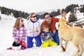 Family with dog having fun in the snow Royalty Free Stock Photo