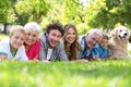 Family with dog lying on the grass in the park