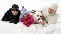 Family with dog playing in snow Royalty Free Stock Photo