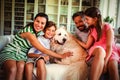 Family with dog sitting on sofa in living room Royalty Free Stock Photo