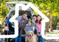 Family and dog standing on the road against home outline in background