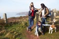 Family With Dog Walking Along Coastal Path Royalty Free Stock Photo