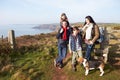 Family With Dog Walking Along Coastal Path Royalty Free Stock Photo