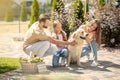 Young family stroking their pet and looking happy