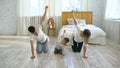 Family doing gymnastic exercises in bedroom at home - healthy life education Royalty Free Stock Photo