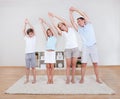 Family Doing Stretching Exercises On The Carpet Royalty Free Stock Photo