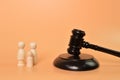 Family doll figures standing with judge gavel. Family law concept Royalty Free Stock Photo