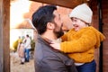 Family With Down Syndrome Daughter Getting Ready To Go For Autumn Or Winter Walk Together