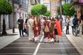 Family dressed as Romans of the imperial era walking through the streets