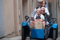 Family dressed for heritage day on a blue Three wheeler