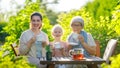 family drinking tea in the garden Royalty Free Stock Photo