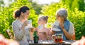 family drinking tea in the garden Royalty Free Stock Photo