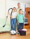 Family dusting with vacuum cleaner