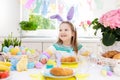 Kids at Easter breakfast. Eggs basket, bunny ears. Royalty Free Stock Photo