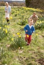 Family On Easter Egg Hunt In Daffodil Field Royalty Free Stock Photo