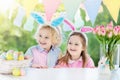 Kids with bunny ears and eggs on Easter egg hunt. Royalty Free Stock Photo