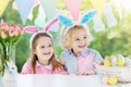 Kids with bunny ears and eggs on Easter egg hunt. Royalty Free Stock Photo