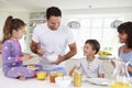 Family Eating Breakfast In Kitchen Together Royalty Free Stock Photo
