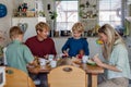 Family eating breakfast together in home kitchen. Healthy breakfast or snack before kindergarden, school and work. Royalty Free Stock Photo