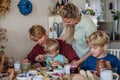 Family eating breakfast together in home kitchen. Healthy breakfast or snack before kindergarden, school and work. Royalty Free Stock Photo